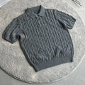 Man wearing a grey knitted short-sleeve T-shirt made from twisted combed cotton blend.