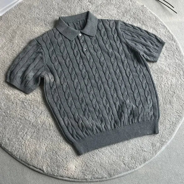 Man wearing a grey knitted short-sleeve T-shirt made from twisted combed cotton blend.
