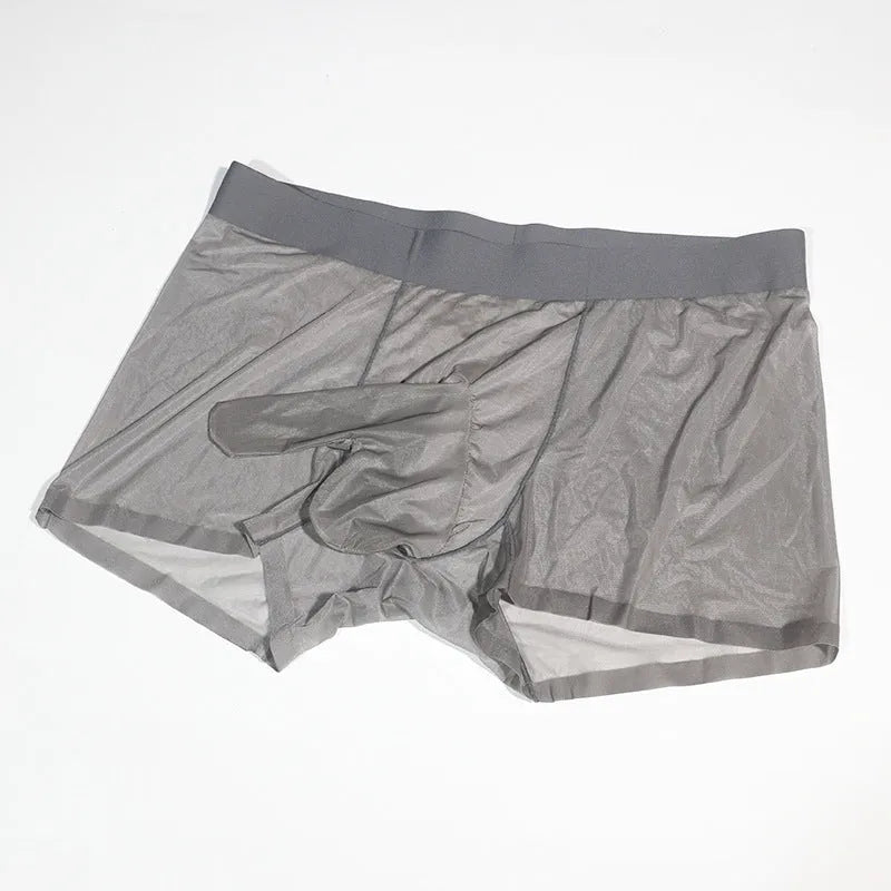 Men's plus size ice silk transparent seamless shorts in skin colour on a grey background