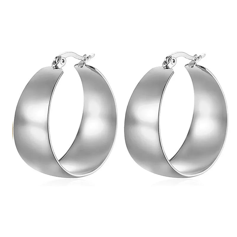 Widened curved stainless steel earrings with titanium content in gold or steel colour