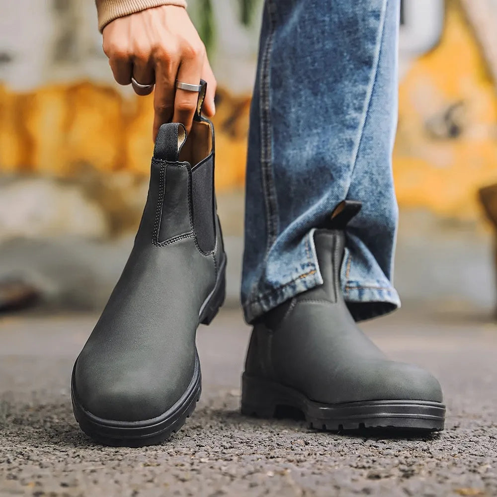 Vintage-style unisex brown Chelsea boots with a frosted PU upper and round toe on a wooden floor.