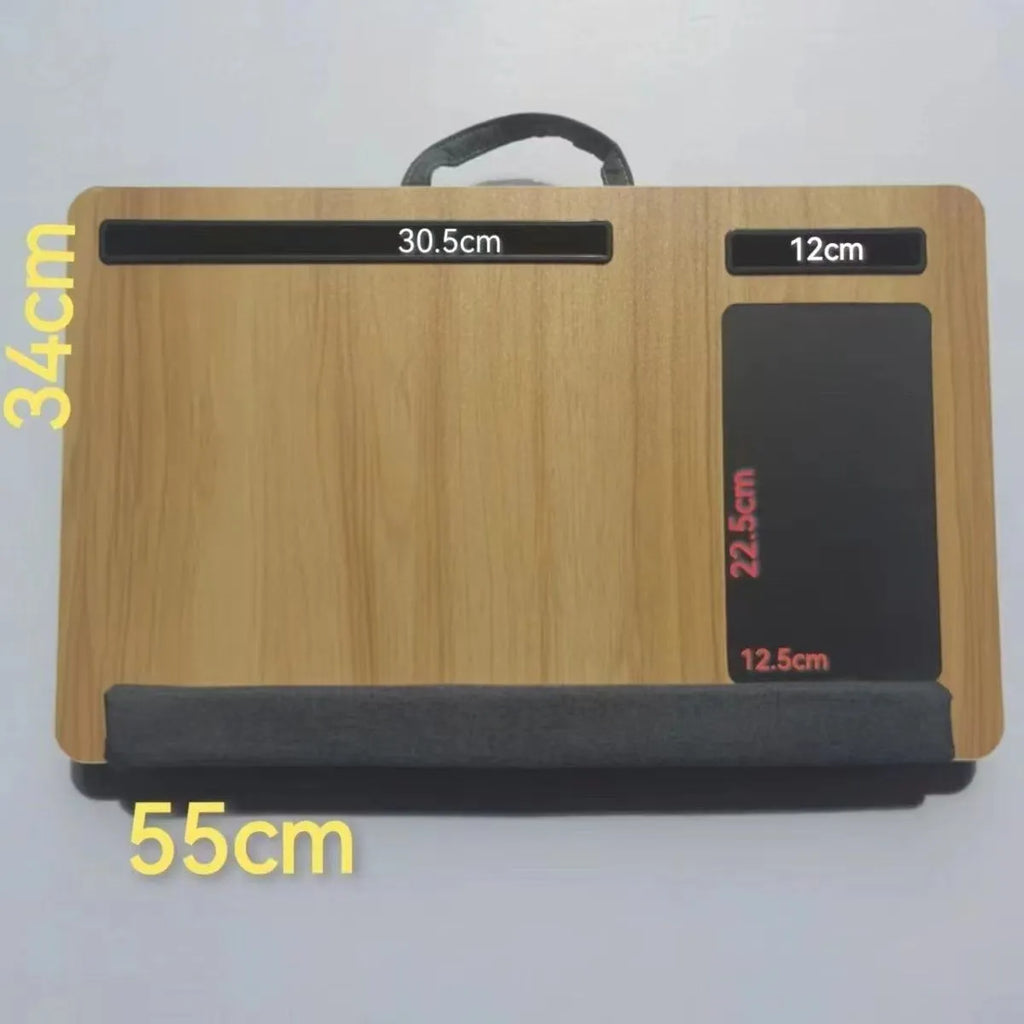 Foldable laptop desk in black walnut colour on a bed, showing open leg supports.