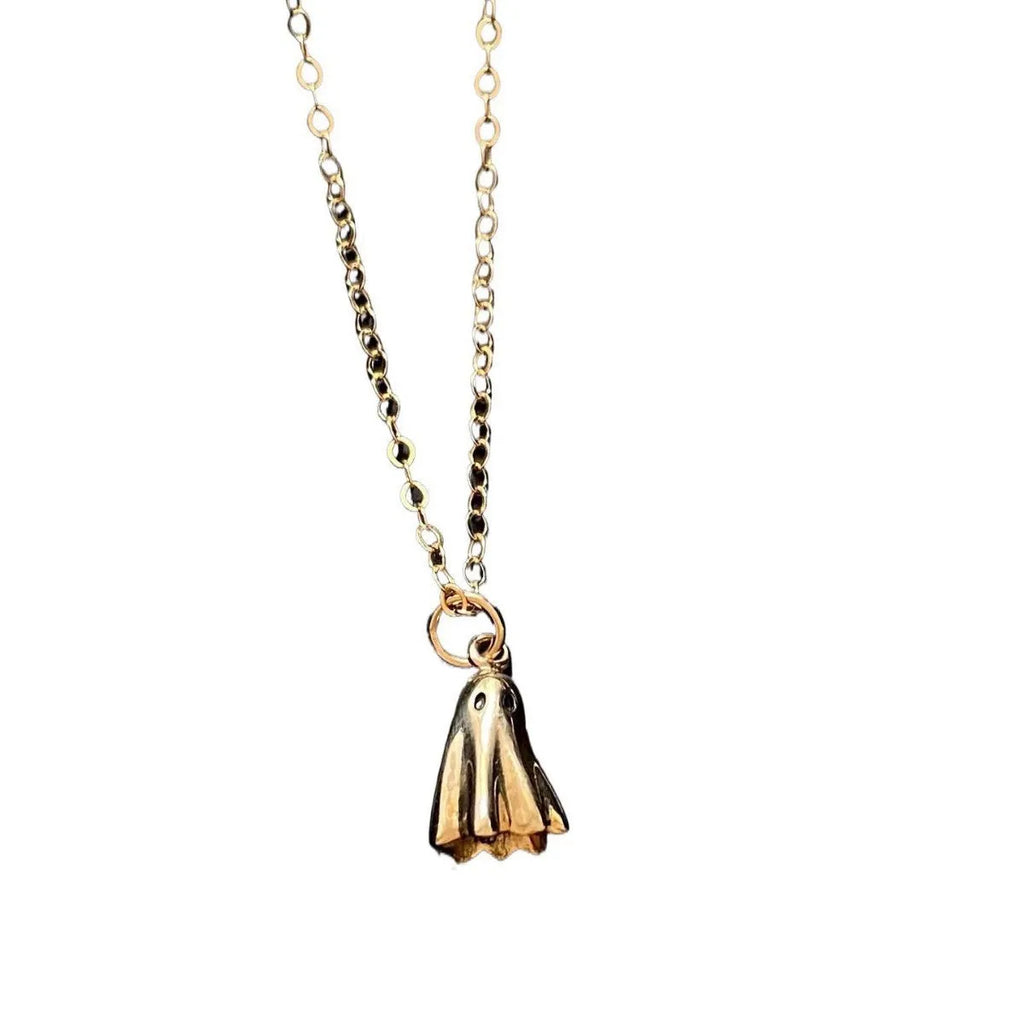 Ghost pendant necklace with twisted stainless steel chain on a person.