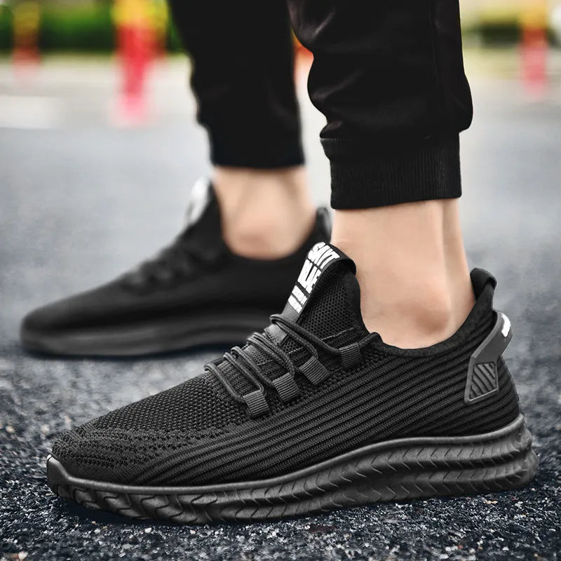 Men's casual shoes with black flying weave upper, rubber sole, and front tie lacing