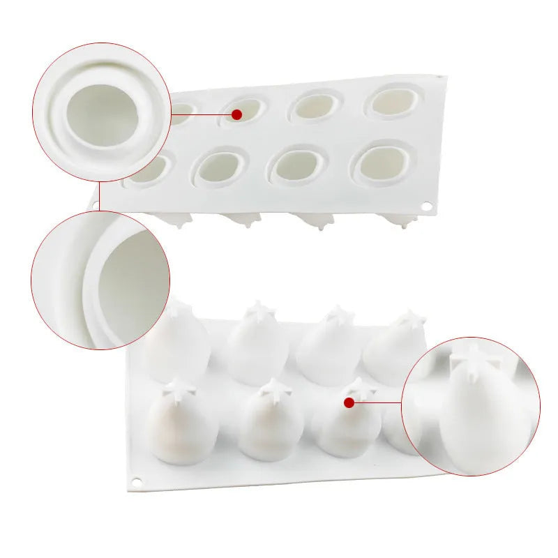 Set of six silicone baking moulds shaped as pineapples, pine cones, and pears on a kitchen counter.