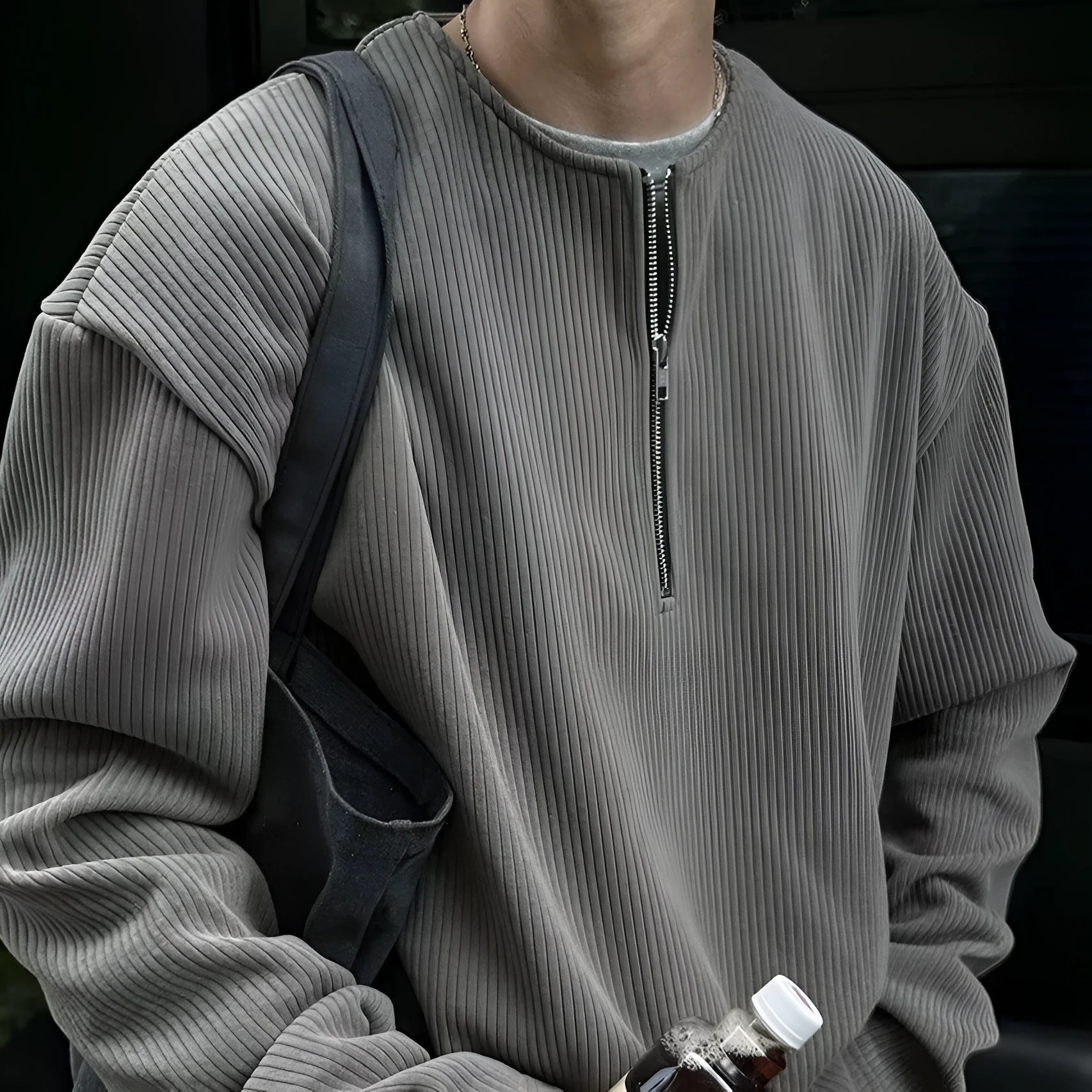 Men's solid grey loose-fit long sleeve pullover top on a hanger.
