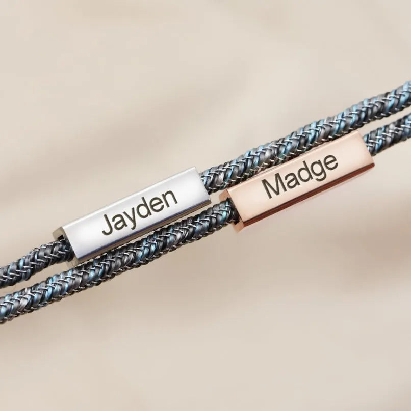 Pair of stainless steel magnetic bracelets for couples, silver and rose gold finish, with adjustable hand rope