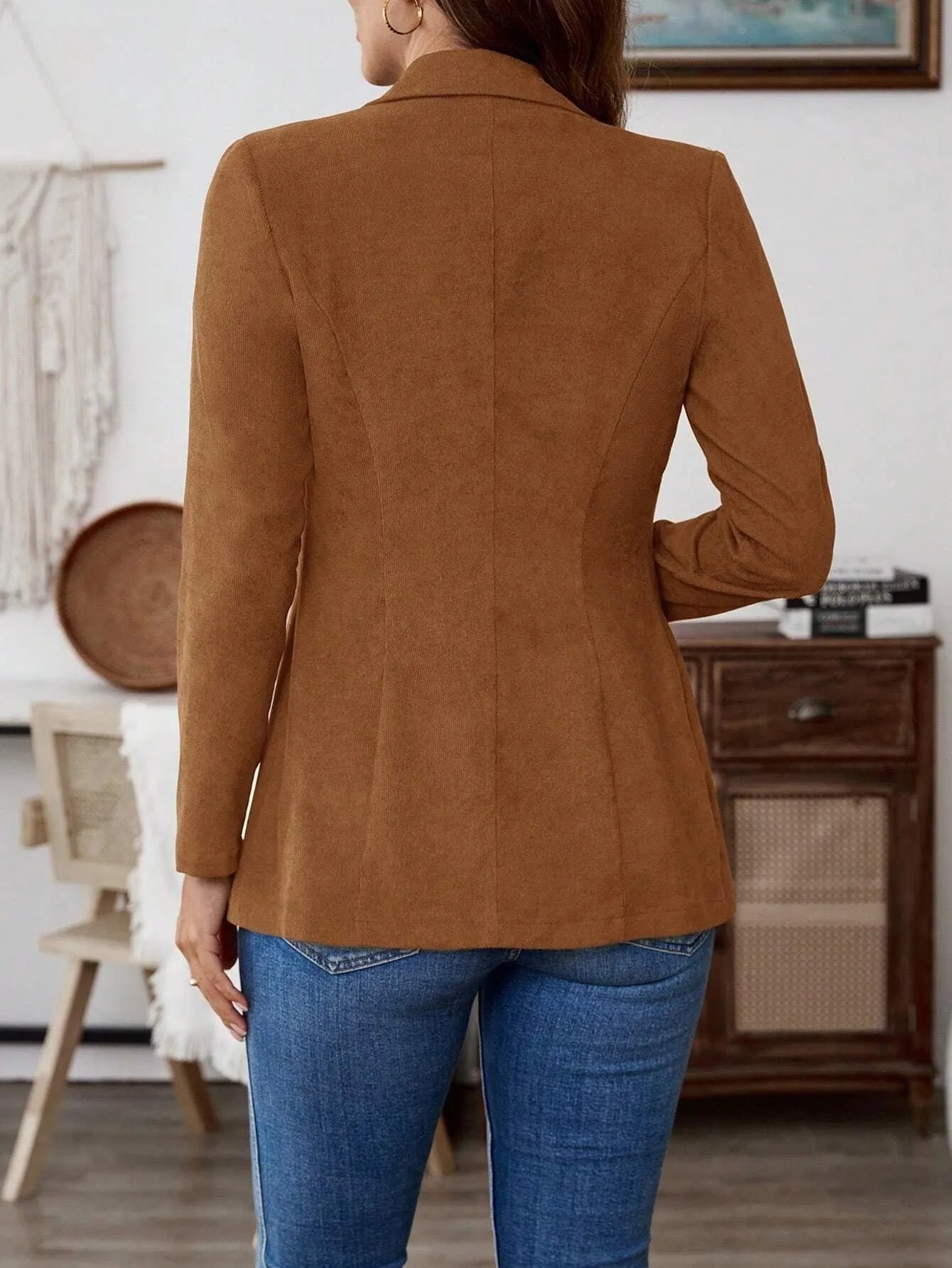 Brown single-breasted lapel blazer for men on a hanger.