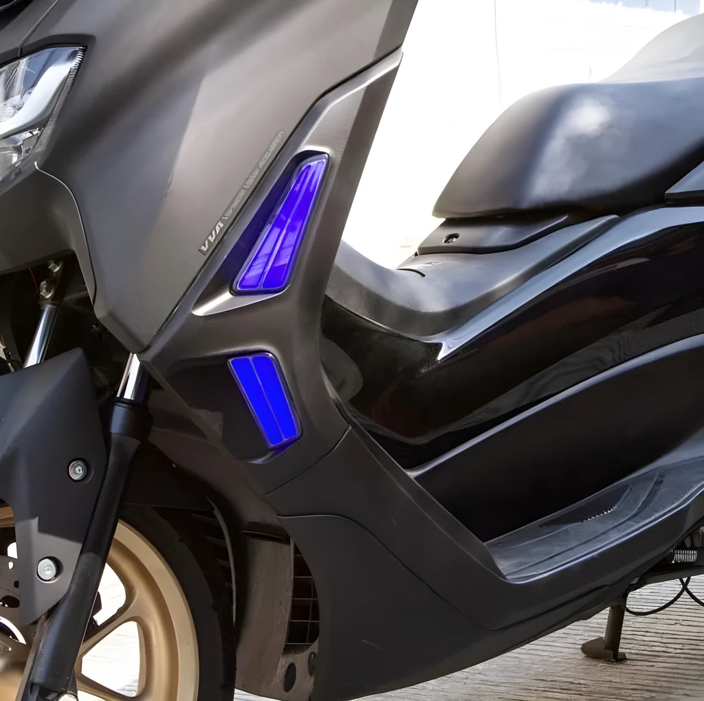 Pair of white and yellow LED turn signal lights mounted on a Yamaha NMAX155 scooter's steering column