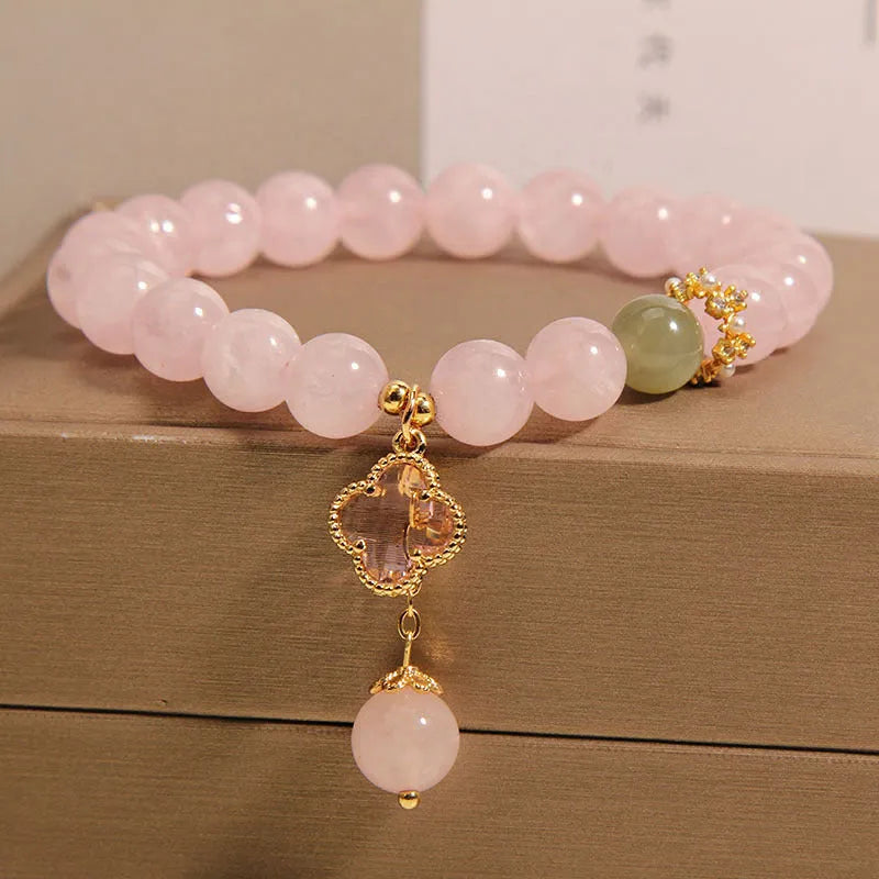 Pink crystal women's bracelet with four-leaf clover pendant and rhinestone details