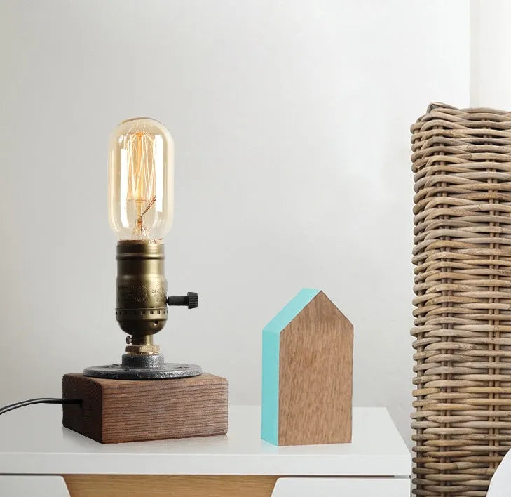 Wood and iron water pipe table lamp measuring 9 cm wide by 13 cm high