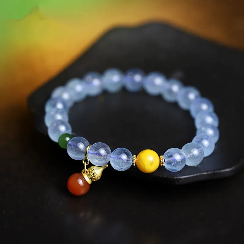 Iced aquamarine crystal bracelet with geometric arrangement of 8mm stones and adjustable cord