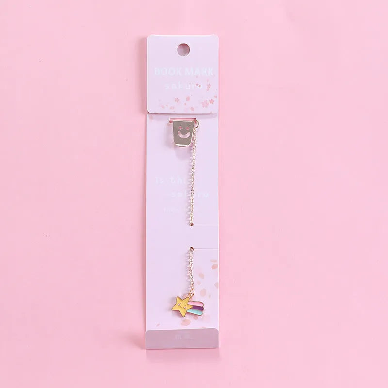 Cartoon-themed alloy metal bookmark charm on a book page.