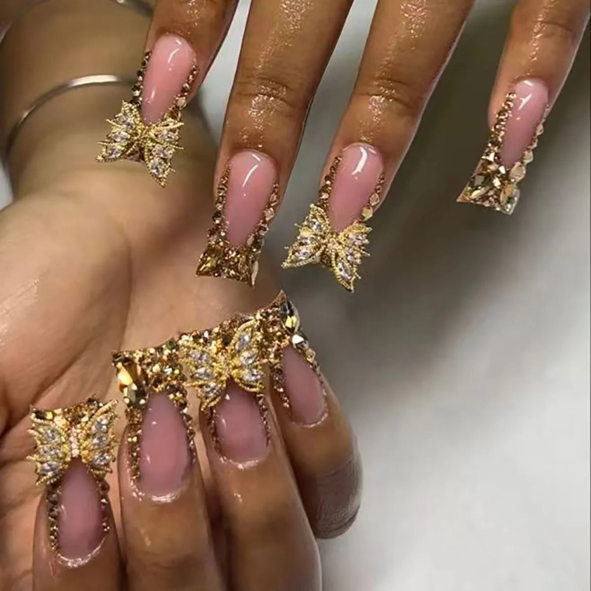 24 golden diamond and butterfly debris nail stickers in colour D34 with a tube of glue.