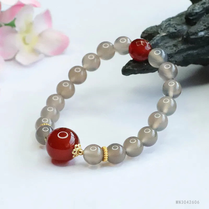 Women's smoky purple agate bracelet with 8mm geometric beads on a white background.