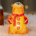Glowing LED Christmas ornament of a gingerbread man with a red scarf.