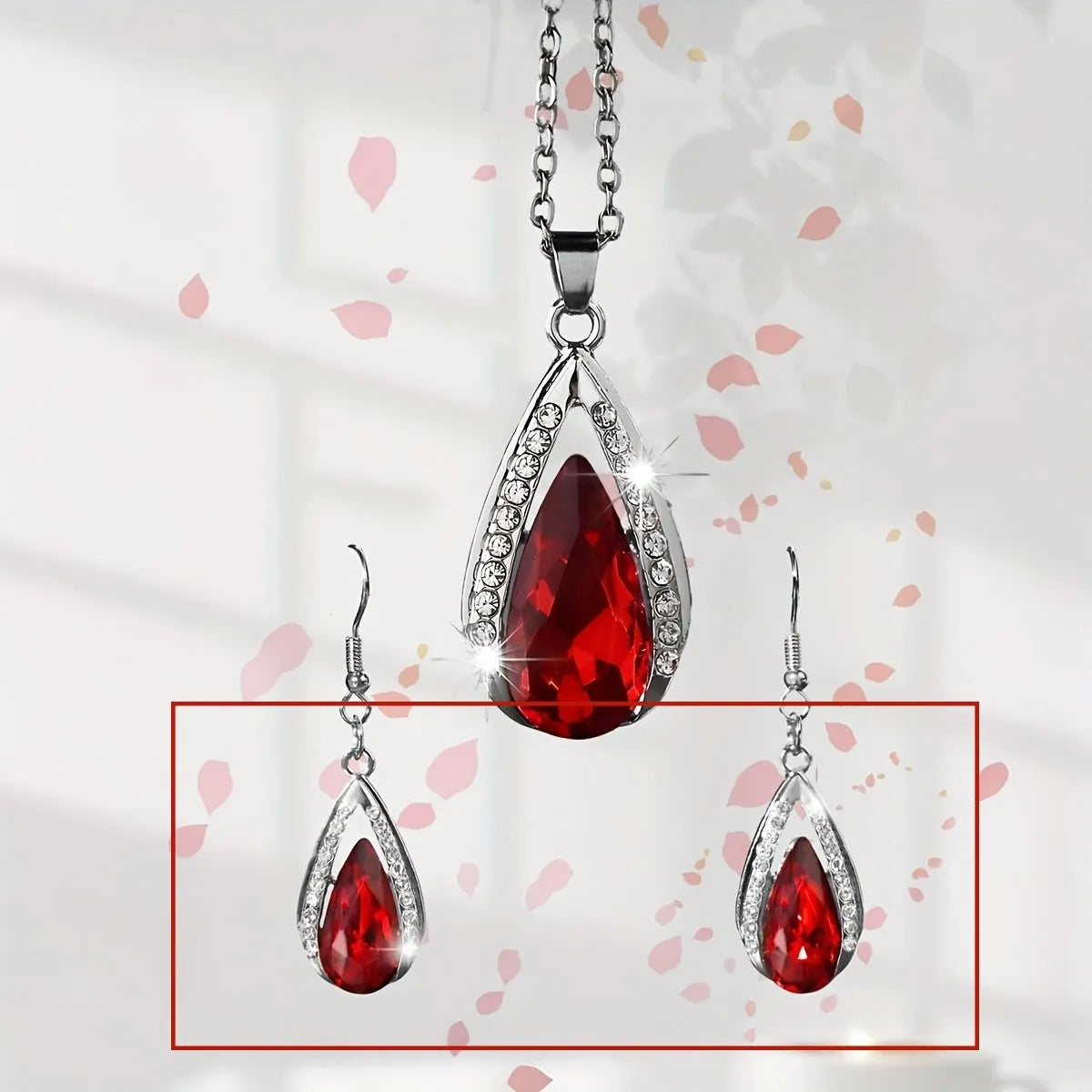 Black and red teardrop-shaped glass pendant necklace and matching earrings set on alloy chain.