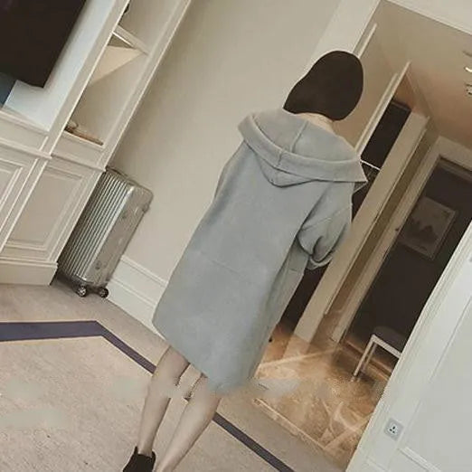 Plus size woman wearing a thin grey cotton coat with lace detail, loose fit long sleeves.