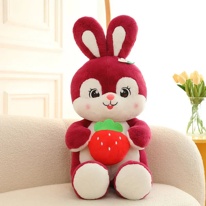 Cartoon strawberry rabbit plush toy doll pillow in pink sitting on a surface