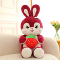 Cartoon strawberry rabbit plush toy doll pillow in pink sitting on a surface