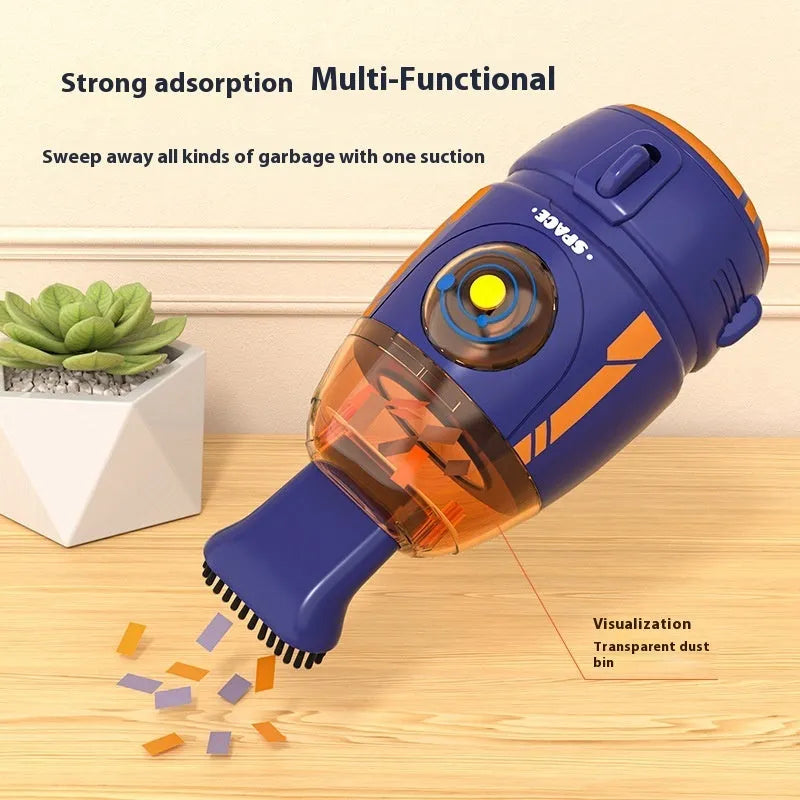 USB-powered handheld desktop vacuum cleaner in blue, placed next to a keyboard with crumbs.