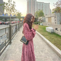 Red knitted cotton midi dress with floral pattern and 3/4 princess sleeves on a mannequin.