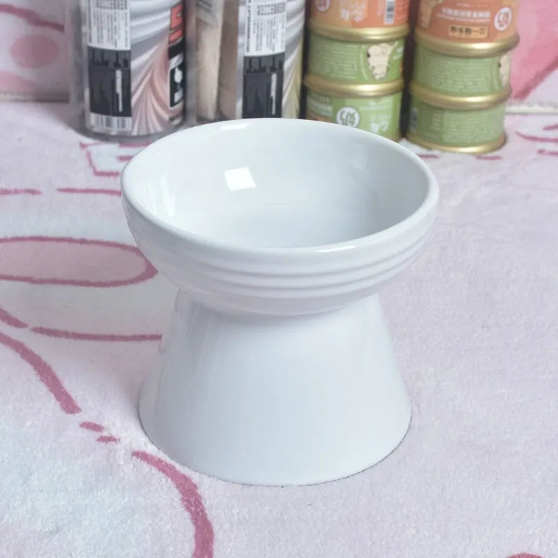 White ceramic pet bowl with a high foot base and wide, shallow eating area for dogs and cats