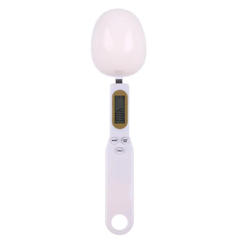 White digital spoon kitchen scale with LCD screen showing weight measurement.