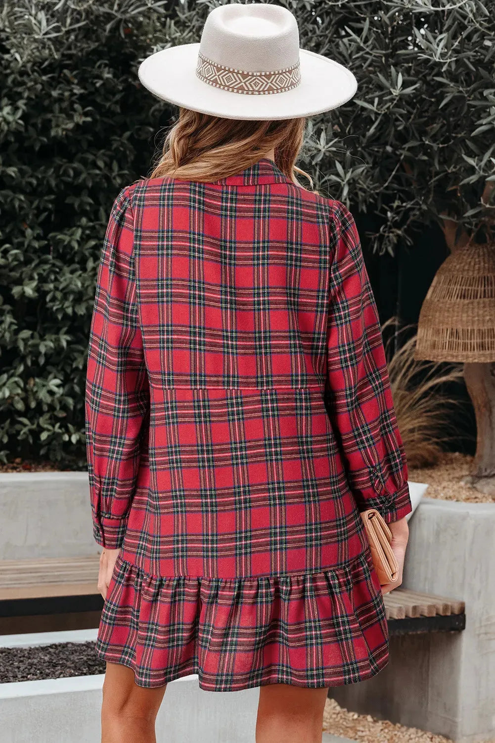 Red plaid mini dress with a shirt collar, long sleeves, half-button front, and a ruffle hem.
