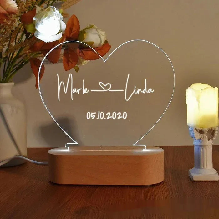 Custom transparent acrylic night light engraved with personal names and a date.