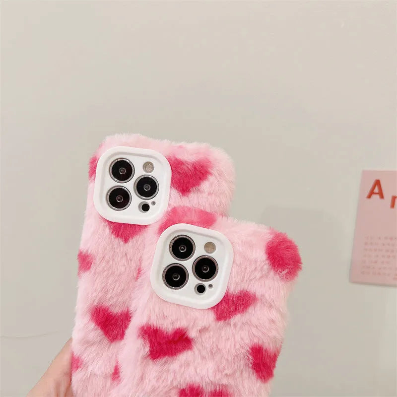 Pink silicone iPhone case with cartoon Love Plush design, shown fitted on a mobile phone.