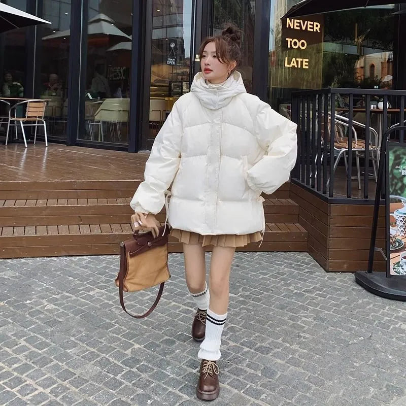 Women's loose black winter jacket with princess sleeves on a hanger.