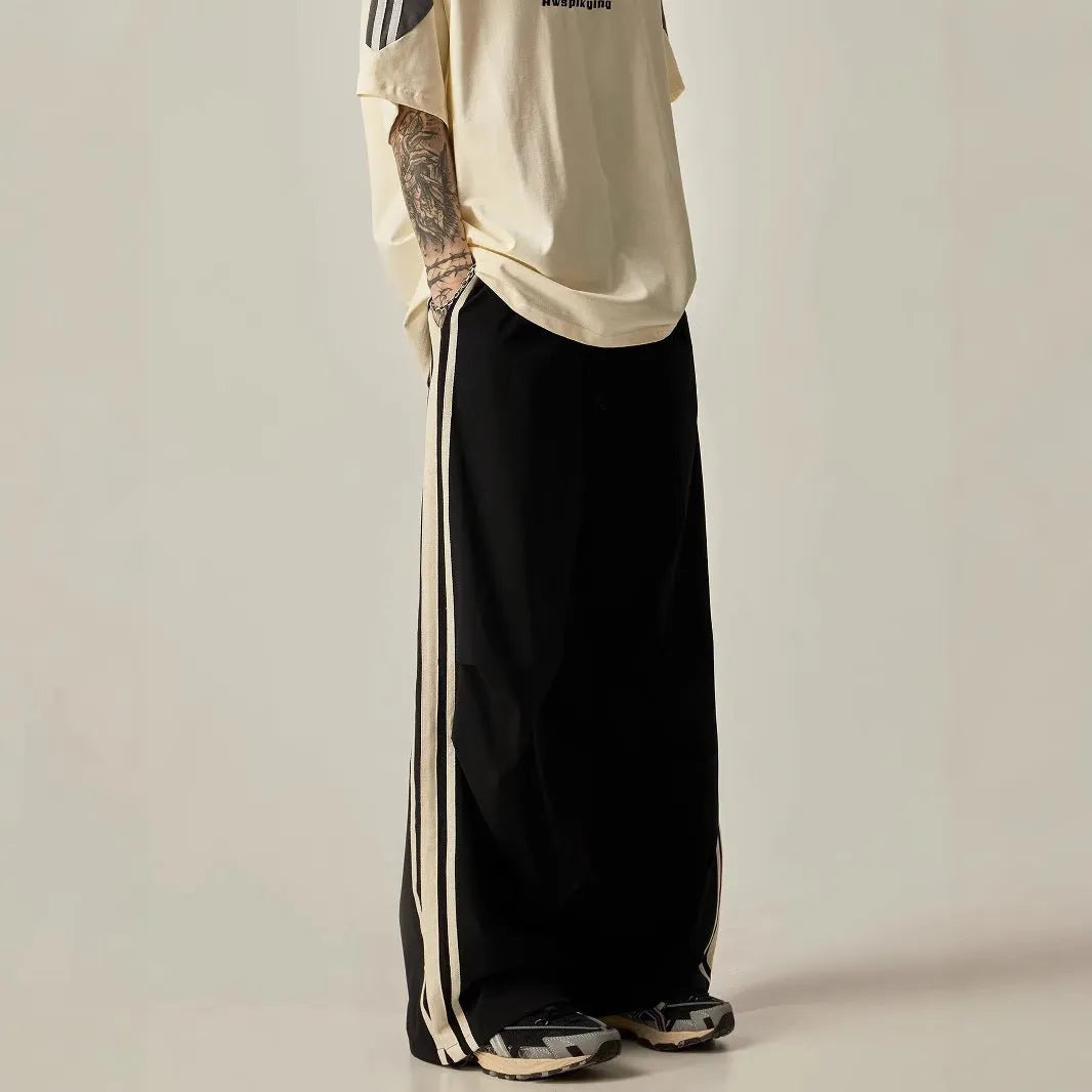Black men's high-waisted wide-leg casual trousers laid flat.
