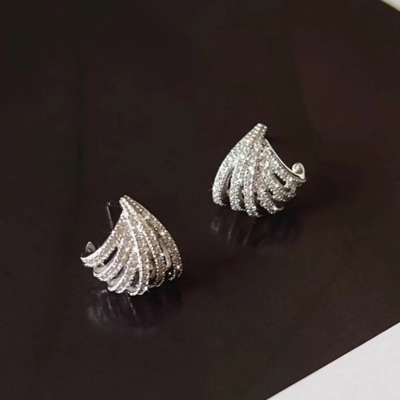Geometric platinum-coloured zircon earrings for women on a white background.