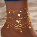 Set of four women's alloy anklets with butterfly and pearl heart designs arranged together