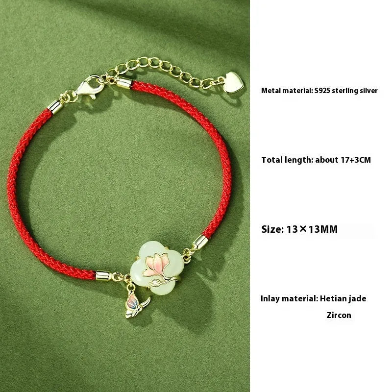 Magnolia flower Hetian jade and sterling silver necklace, bracelet, and earrings set on a white background.