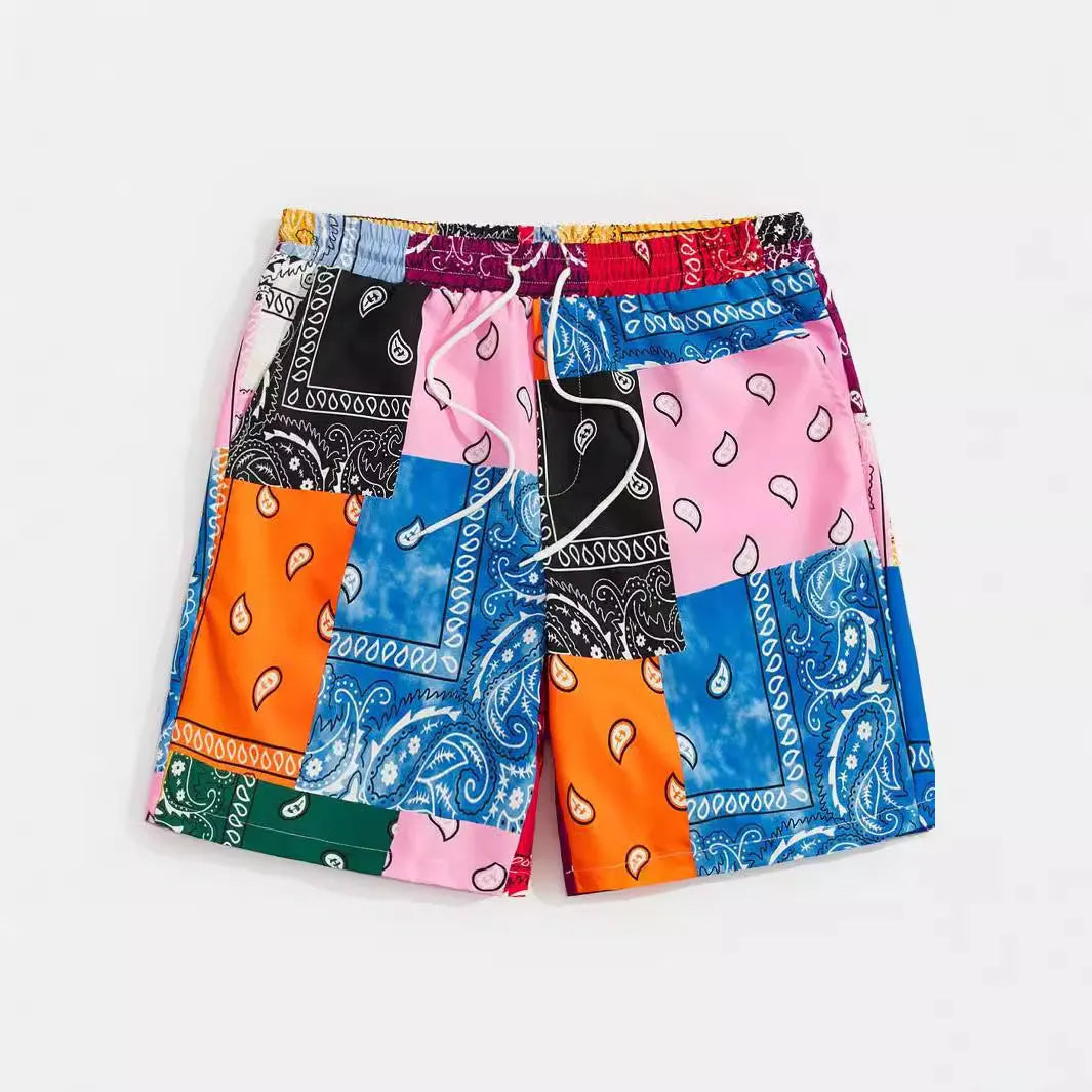 Man's thin polyester mesh beach shorts in a solid colour with a printed design, laid flat.