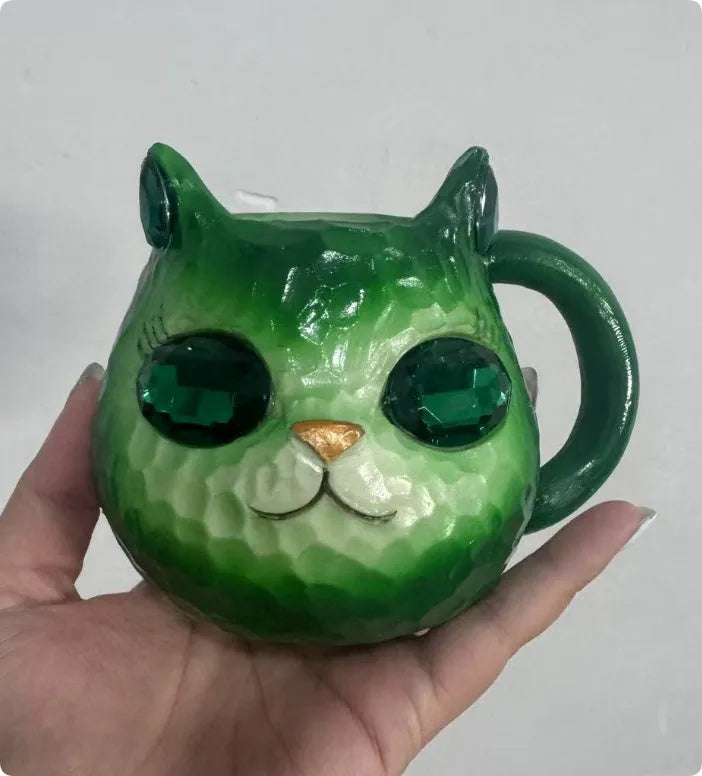 Resin cat cup ornament with crystal earth design in blue, green, pink, or purple colour options.
