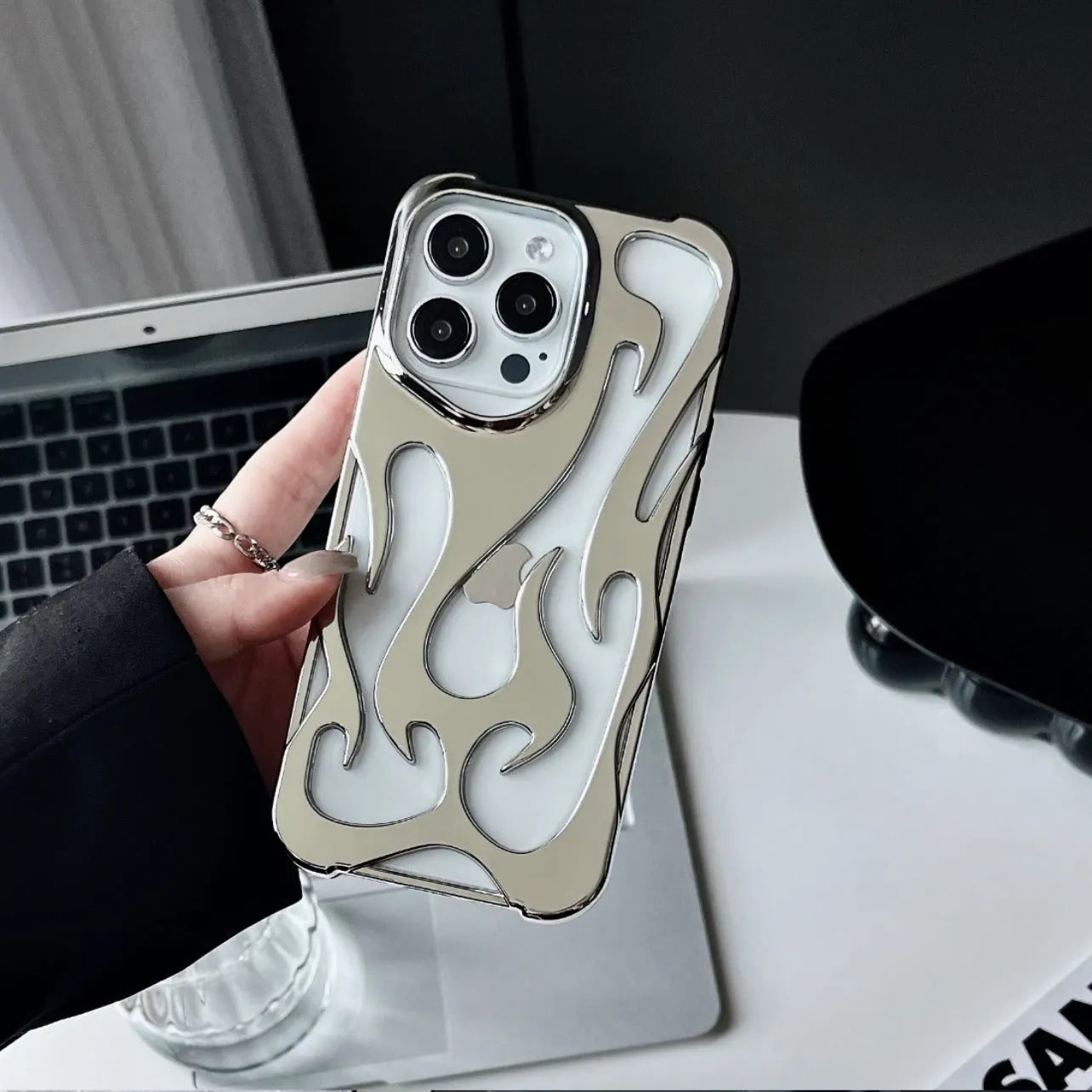 Electroplated hollow flame pattern soft TPU phone case for Apple iPhone, shown in silver on a dark background.