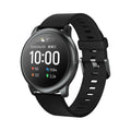 Black round smart watch with heart rate and sleep monitor on wrist, alloy case and silicone band