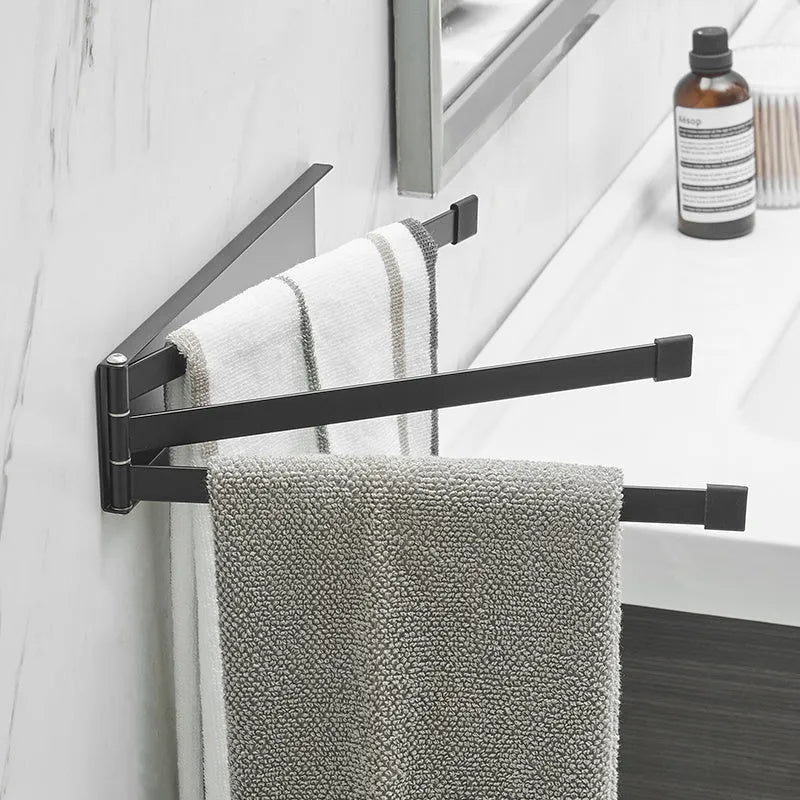 Nordic style black folding towel rack mounted on a bathroom wall with non-perforated installation.