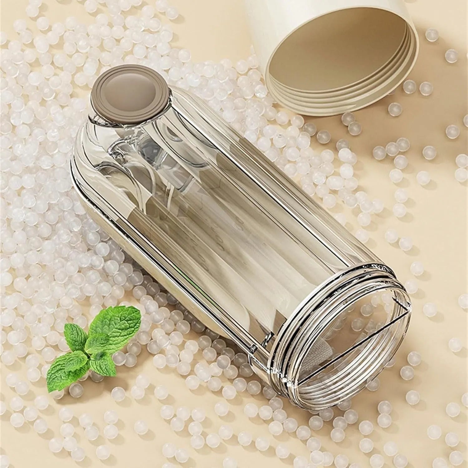 Beige and green foldable dog water bottle with food dispenser for outdoor use.