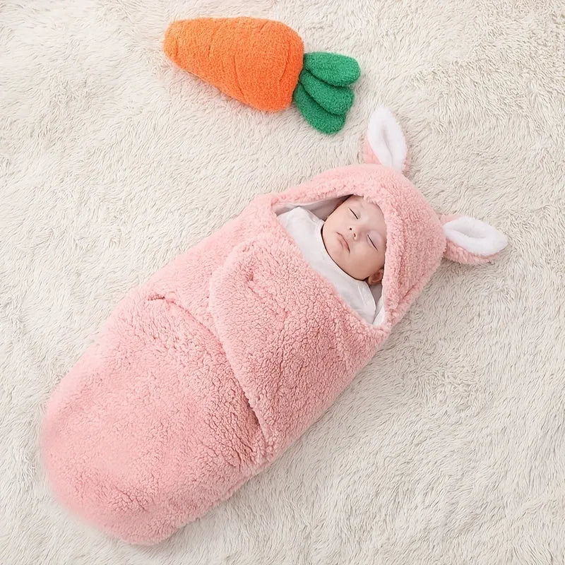 Baby wearing a blue adjustable cotton sleep sack with velcro swaddle closures and a head-protecting hood.