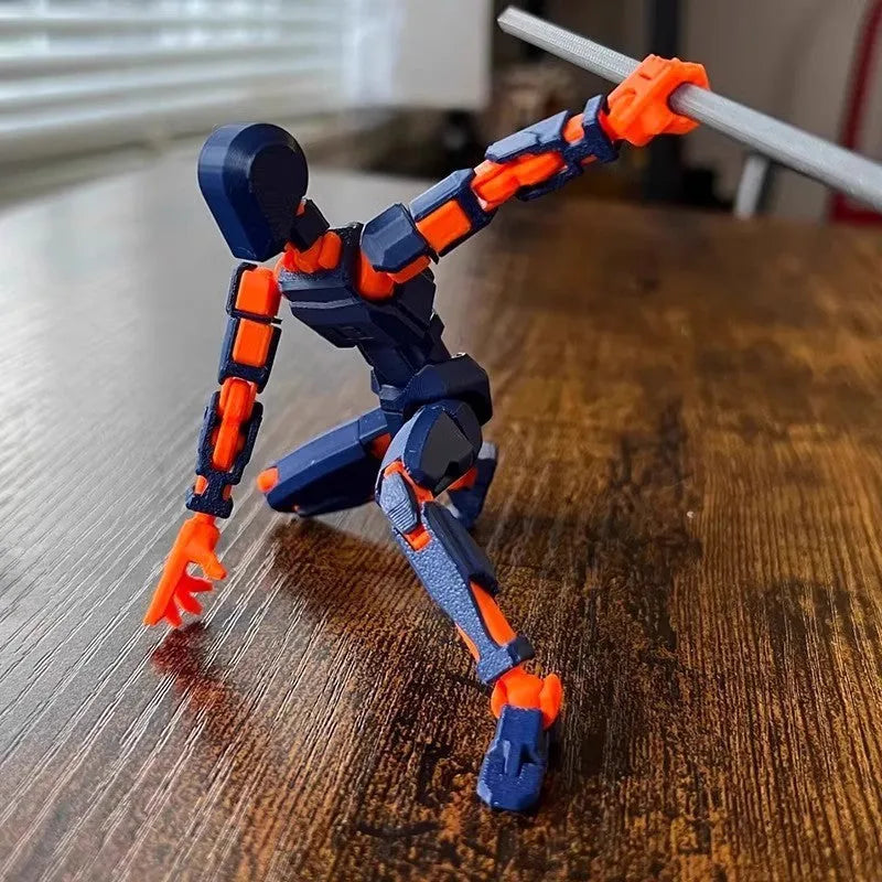 3D printed multi-jointed robot action figure model with movable joints on a desk.