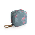 Blue cloth cube-shaped makeup storage bag with a plain pattern on a flat surface.