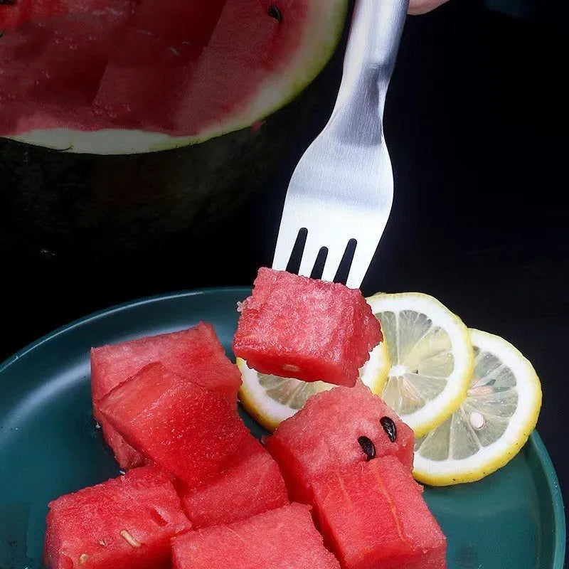 Stainless steel watermelon slicer and fork tool on a kitchen counter
