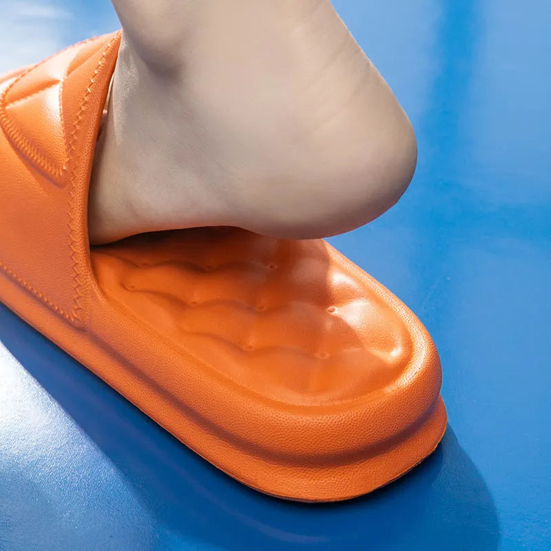 A pair of soft EVA bathroom slippers with a thick sole, shown in a choice of colours including black, caramel, green, pink, and yellow.