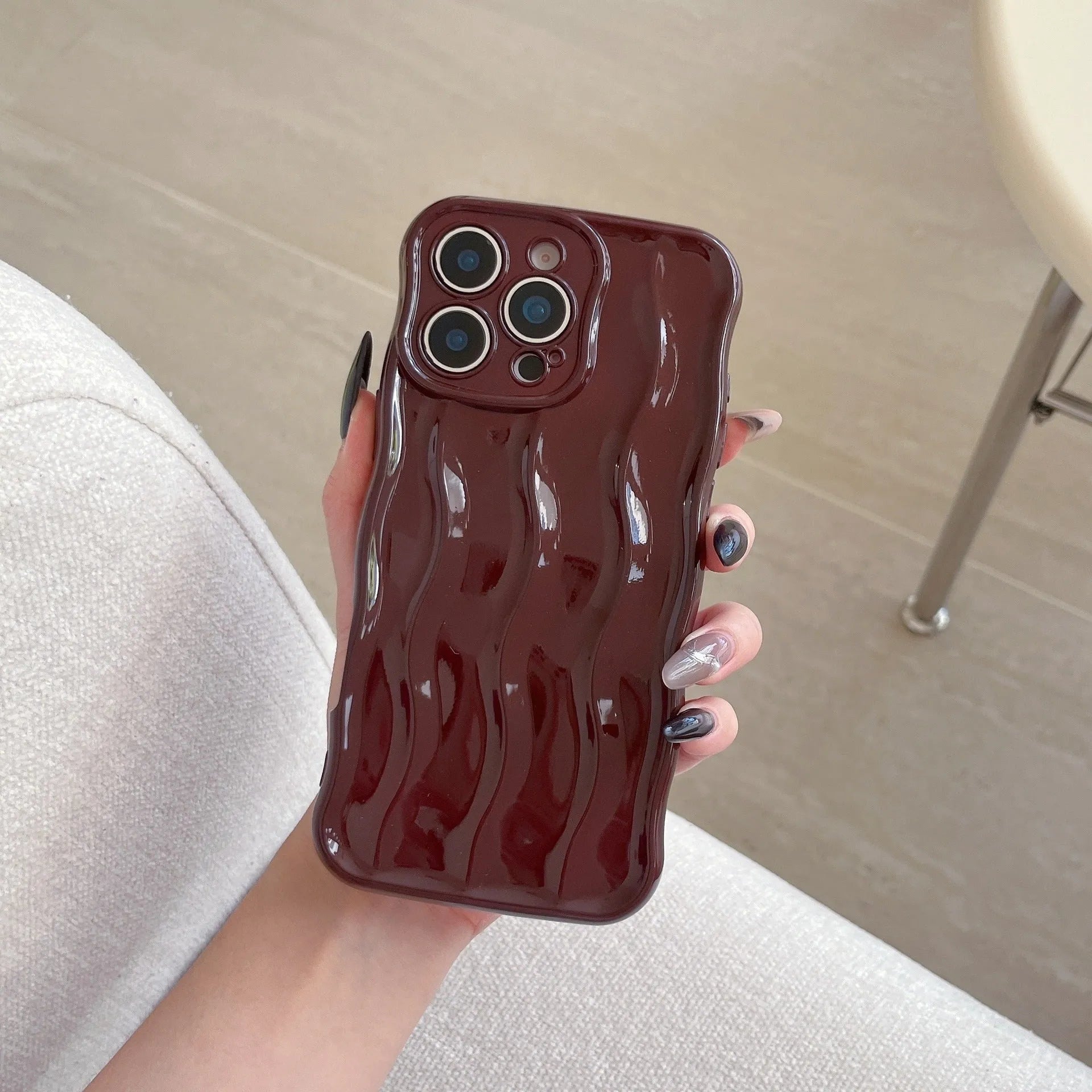 iPhone 17 Pro Max phone case with electroplated silver wave stripe design on black TPU back cover.