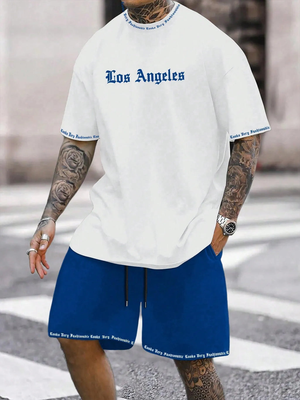 Men's blue sports style short-sleeved top and matching shorts laid flat