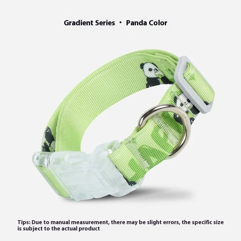 Adjustable nylon dog collar with vibrant cartoon gradient colours and a metal buckle on a green background.